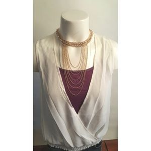 Low cut V neck white blouse.